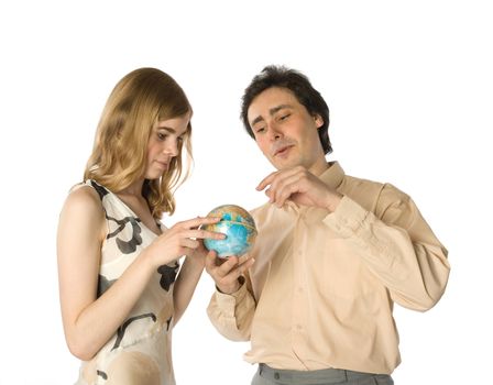 A couple looking at a small globe