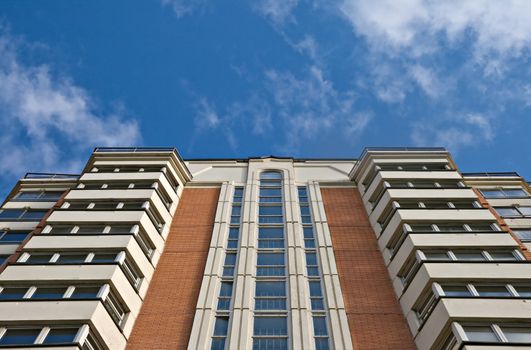 A residential multistory house and sky, view from below