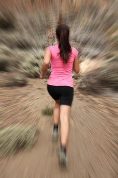 Running - woman runner in motion zoom blur for speed effect. Female running outside in desert.