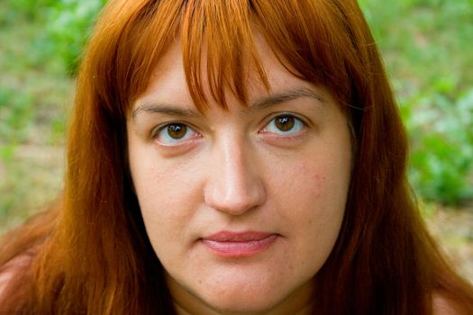 Portrait of the woman against green plants