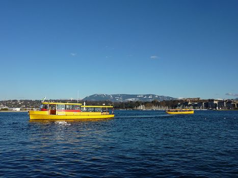 Two yellow boats on Geneva lake, Switzerland, by beautiful weather