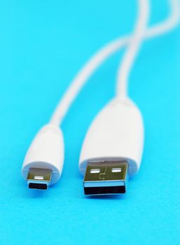 Closeup of white usb cable on blue background