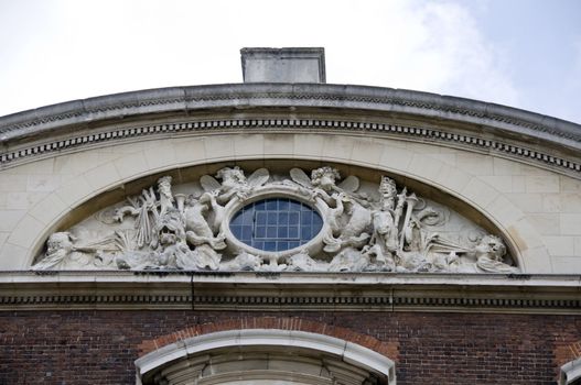 A carving on a building with a round window