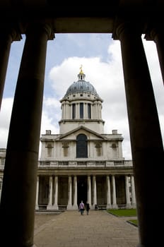 A building with a dome on top framed y two columns