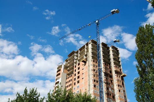 A crane and skyscraper building under construction