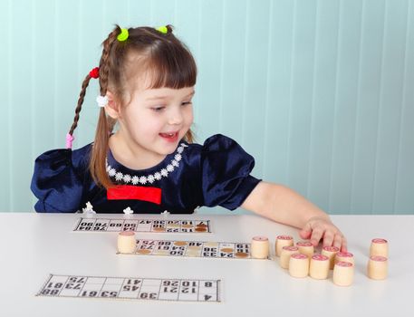 A child playing with enthusiasm sitting at the table