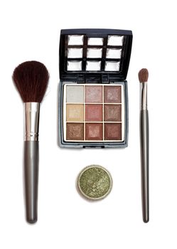 Makeup set with brushes and eye shadows isolated on white