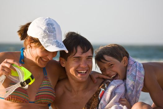 people series: happy mother and two brothers on the beach