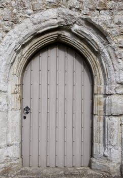 Detail of a wooden church door with stone work
