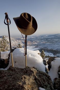 trekking poles and cowboy style hat in winter mountain scenery, Front Range of Rocky Mountains near Fort Collins, Colorado