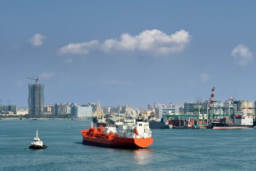Cityscape of ocean with freighter on water of harbor in daytime in Kaohsiung, Taiwan.