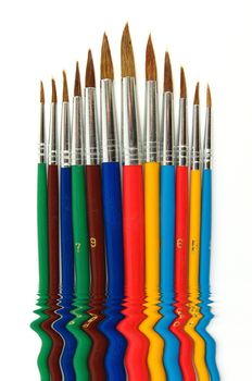 Some colored paintbrushes over a white background