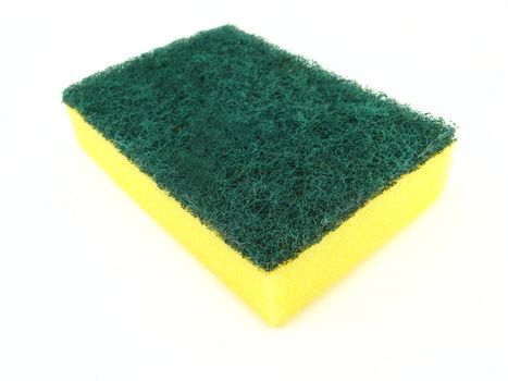 a yellow and green sponge over a on a white background