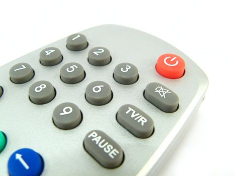 close-up of a remote control over a white background