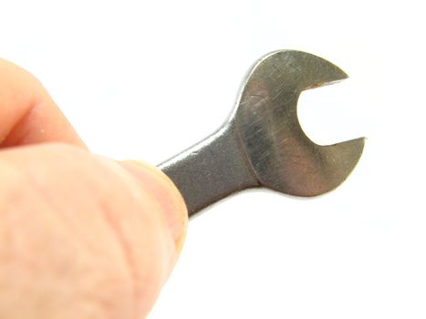 image of hand holding a spanner over a white background