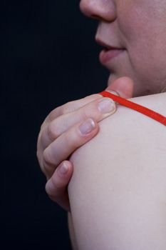 Woman removing her red bra