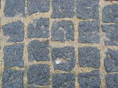 A texture of the stone pavement of a street