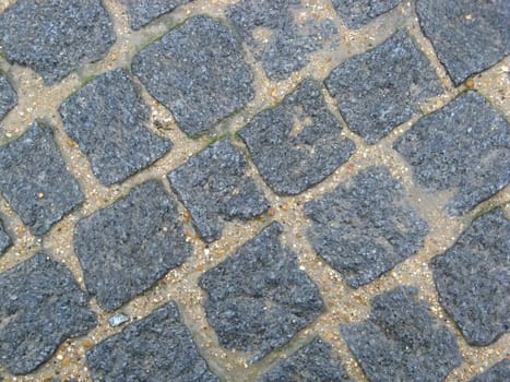 A texture of the stone pavement of a street