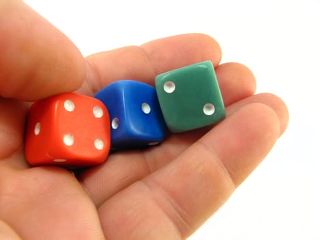 hand holding red, blue and green dices