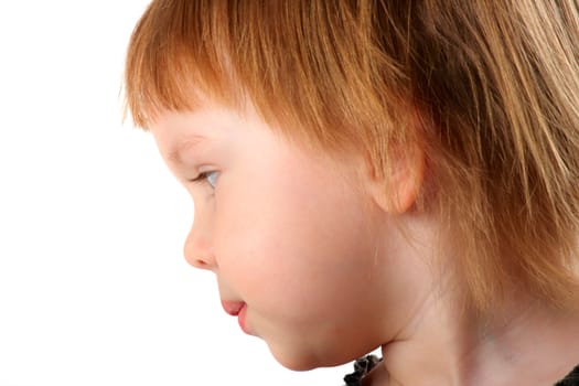 Close-up profile portrait of two-years old beauty girl. She demonstrate her first haircut.