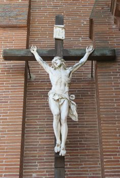 an image of a crucifixion figure near a church