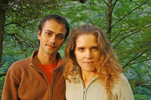 young couple posing in autumn forest