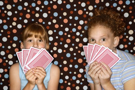 Caucasian female children holding cards.