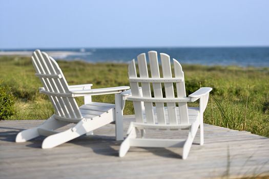 Adirondack chairs on deck looking towards beach on Bald Head Island, North Carolina.