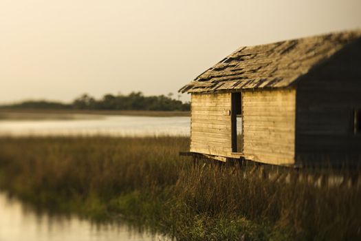 Worn out building in marsh at sunset on Bald Head Island, North Carolina.