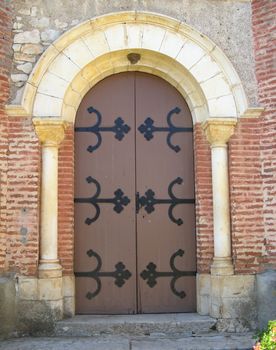 entrance door of the church of Les masseries in Saint-Gery - France