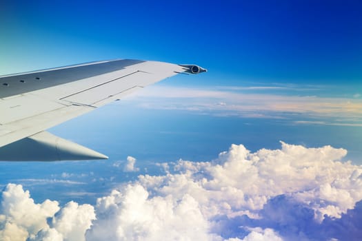 Wing of the plane on a background of sky