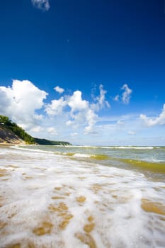 Sea surf wave break on tropical coastline