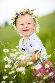 happy small girl with field flowers