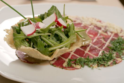 restaurant table with radish rucola and prosciutto