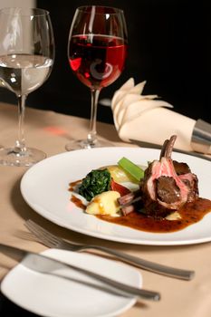 restaurant table with a plate of lamb meal