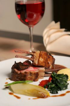 restaurant table with a plate of lamb meal