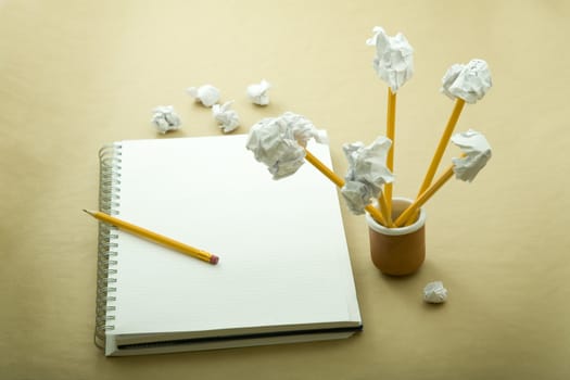 flower made of crumpled paper, notebook and pencil