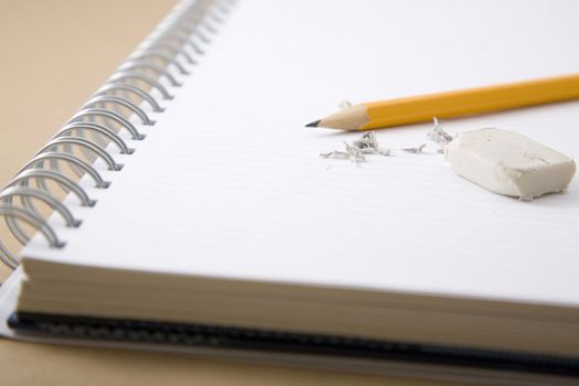 pencil, eraser and eraser leftovers on notebook