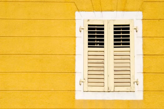 Yellow wall an and wooden window