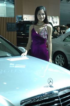 Chinese model. Girls promoting modern cars during Shenzhen Moto - car show in China.