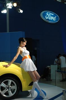 Chinese model. Girls promoting modern cars during Shenzhen Moto - car show in China.