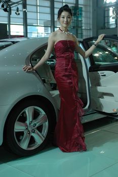 Chinese model. Girls promoting modern cars during Shenzhen Moto - car show in China.