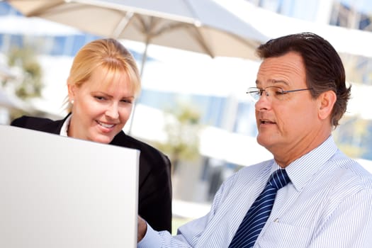Handsome Businessman Working on the Laptop with Attractive Female Colleague Outdoors.
