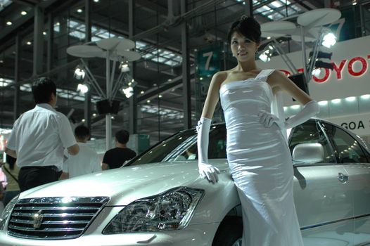 Chinese model. Girls promoting modern cars during Shenzhen Moto - car show in China.