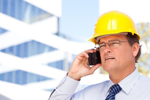 Handsome Contractor in Hardhat and Necktie Smiles as He Talks on His Cell Phone.