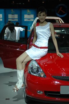 Chinese model. Girls promoting modern cars during Shenzhen Moto - car show in China.