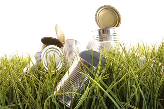 Forgotten empty cans and bottles laying in the grass