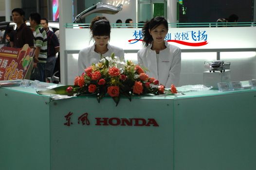 China, Shenzhen Moto - car show in exhibition center. Visitors watching European, American and Chinese cars. Crowd of people interested in newest moto technology.