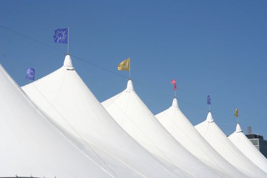 White circus tents with flags