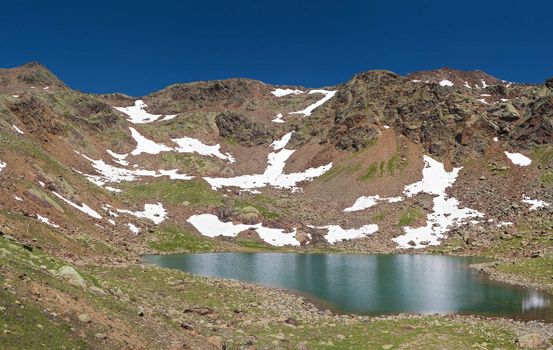 panorama of Marmot lake, in Stelvio National park, Trentino, Italy. Photo taken with polarized filter